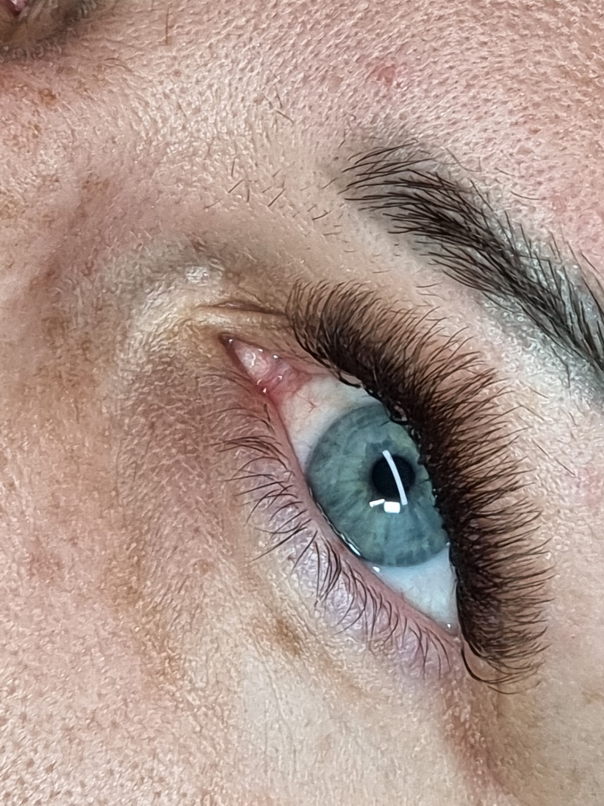 Volume lash extensions on a blue eye, close up